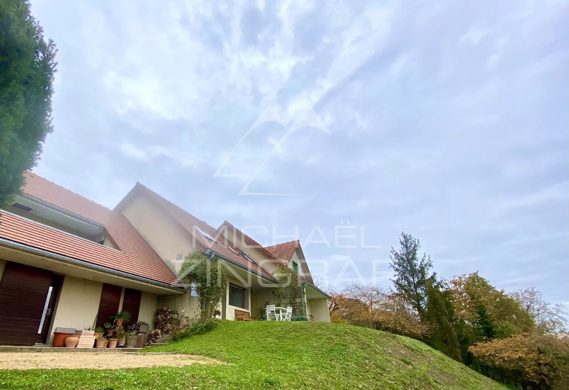 Architect-designed house with land, stables, and riding arena in a commanding position.