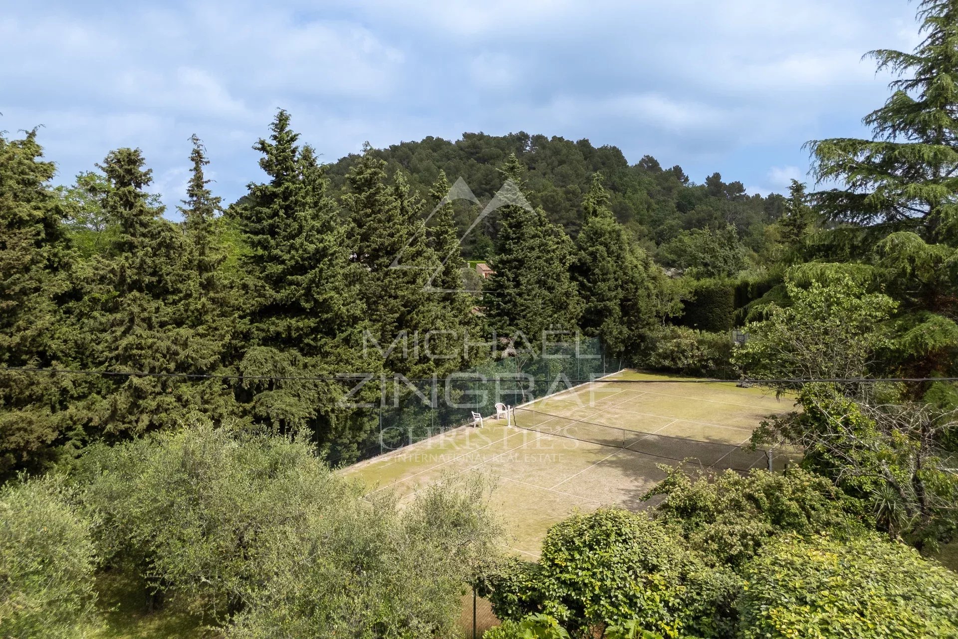 Exceptional estate with private woodland, landscaped grounds, tennis court, and open views